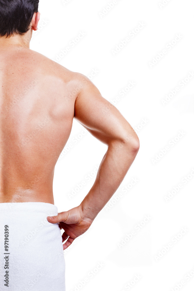 Obraz premium Rear view of a muscled man in towel, isolated on white backgroun