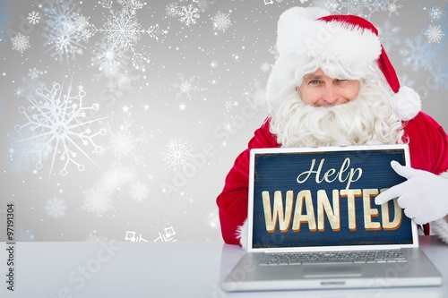 Composite image of santa using laptop