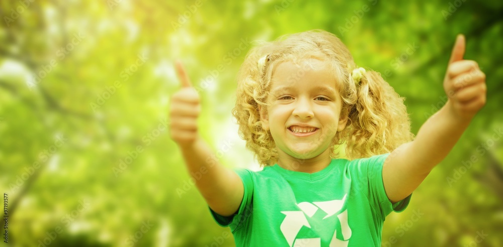 Composite image of happy little girl in green with thumbs up Composite image of happy little girl in green with thumbs up