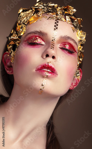 Portrait of a woman with gold makeup