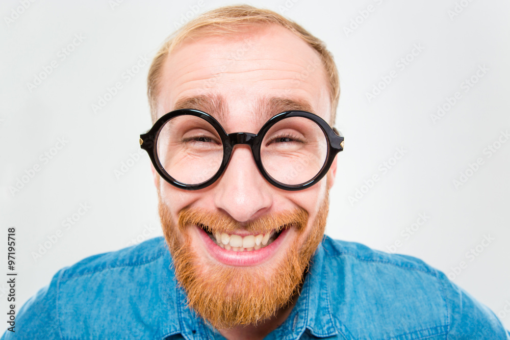 Funny cheerful bearded man in round glasses