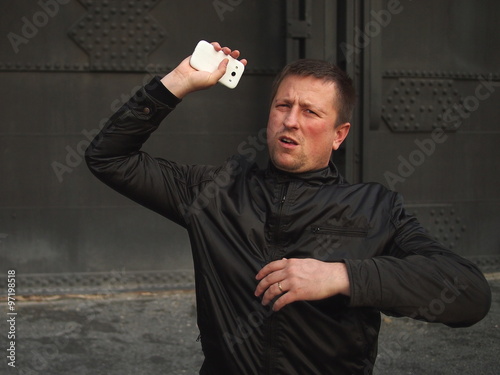 Ged rid of it! Man throwing away a smart phone.