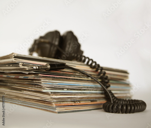 Dingy sepia-style photo of vinyl records and vintage headphones