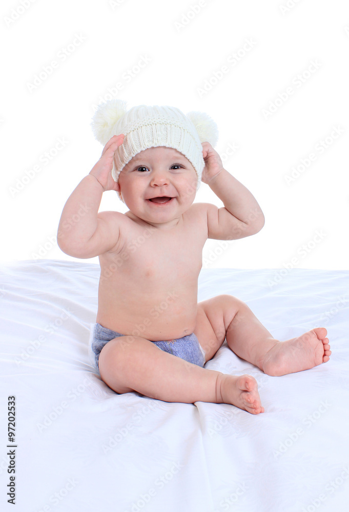 Portrait of adorable baby on the bed in the cap Portrait of adorable baby on the bed in the cap