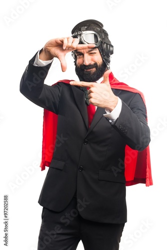 Super hero businessman focusing with his fingers © luismolinero
