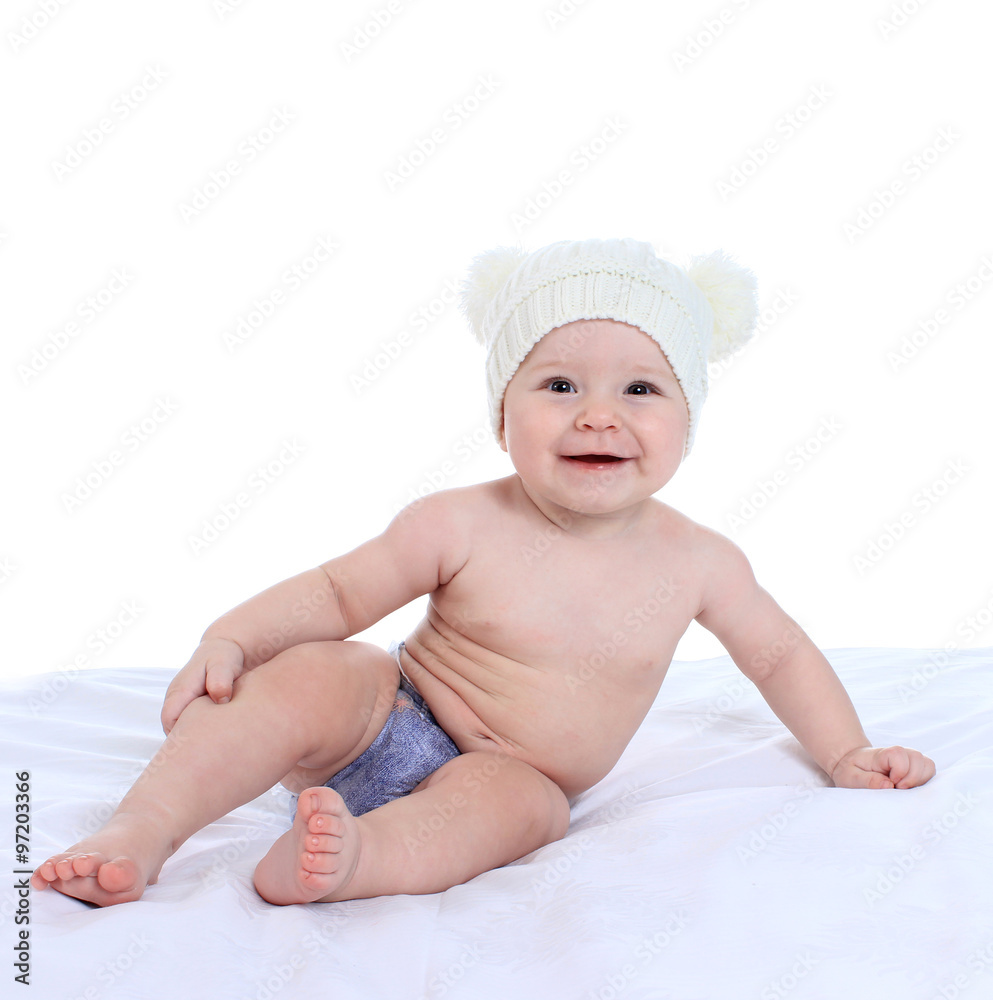 Portrait of adorable baby on the bed in the cap Portrait of adorable baby on the bed in the cap