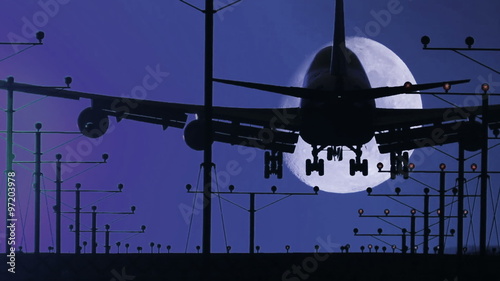 HD footage of a night landing by a jumbo jet as it cross the moon, then rack focuses out at the end.  Audio included