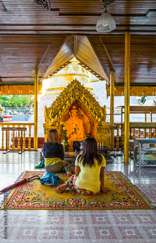 Myanmar, Yangon, religious in prayer in the Swedagon Pagoda.