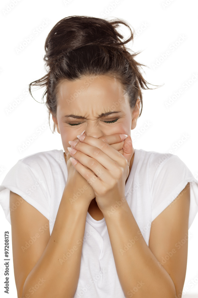 woman has a pain in her mouth and covered it with her hands