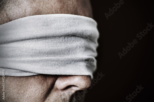 young man with a blindfold in his eyes photo