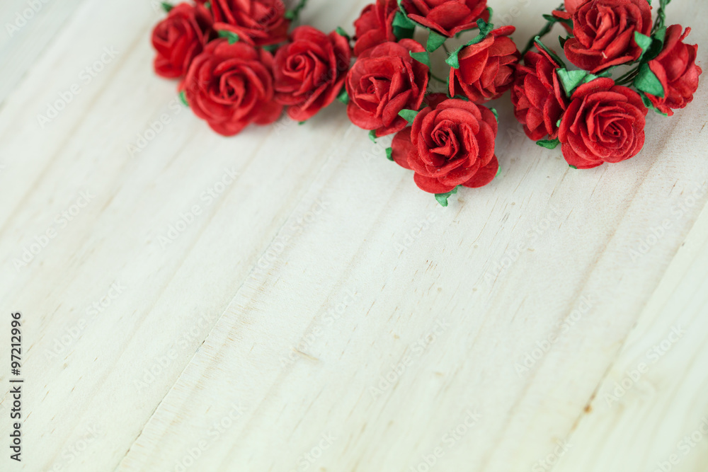 Bunch of red roses in light wood background