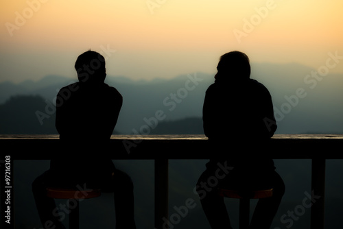 silhouette two man talking each other in the morning