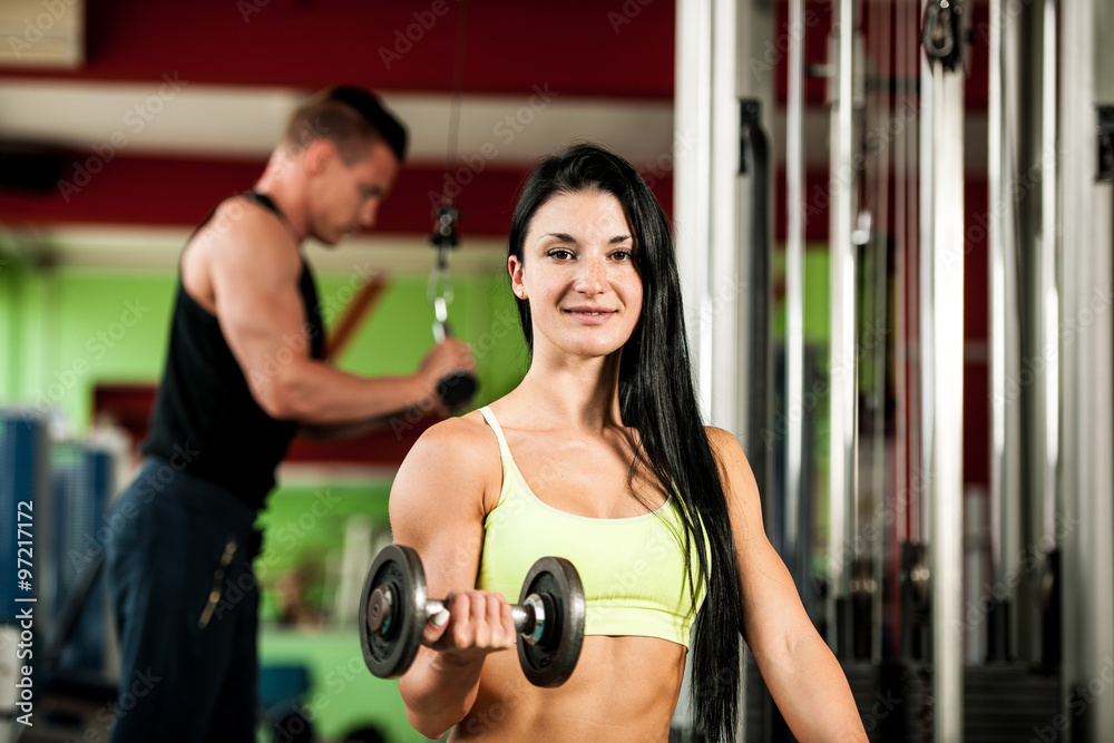 Fitness youple workout - fit mann and woman train in gym Fitness youple workout - fit mann and woman train in gym