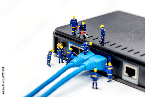 Team of technicians connecting network cable