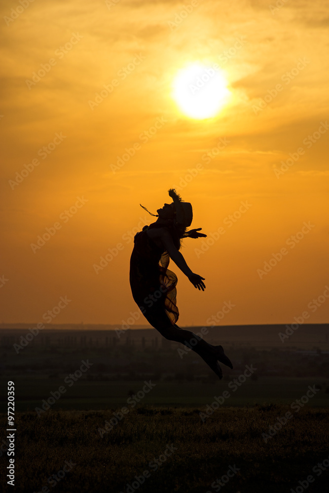 young woman jumping in summer evening young woman jumping in summer evening