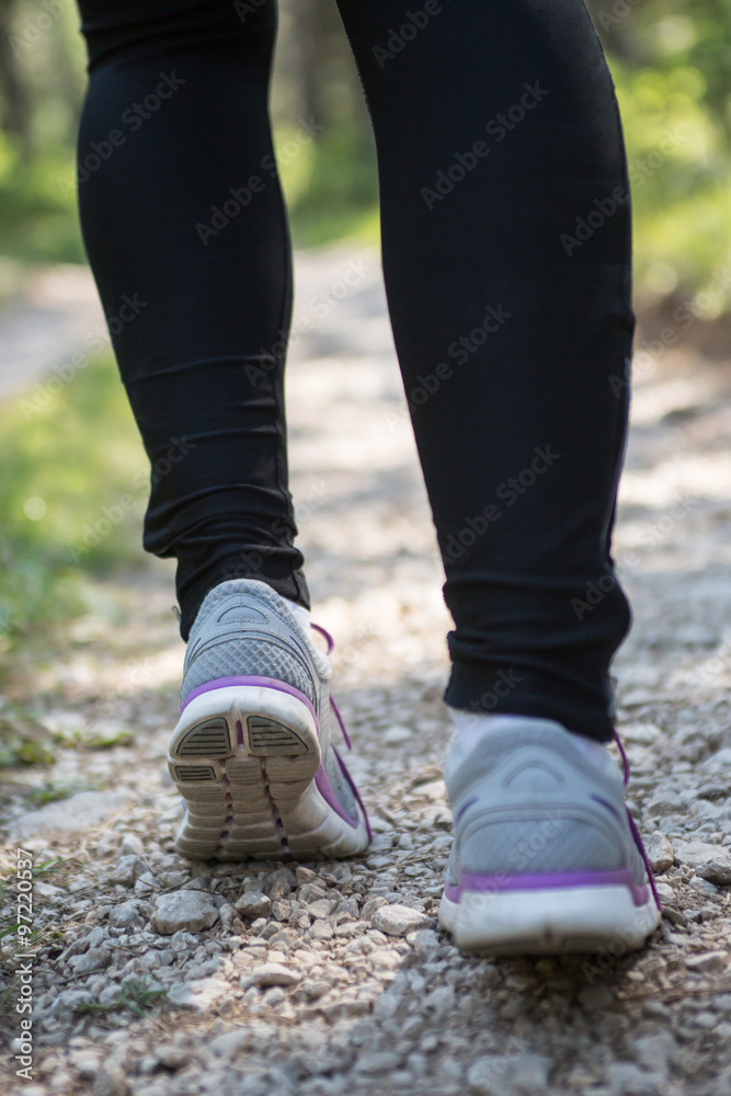 Sport shoes on trail walking in mountains, outdoors activity