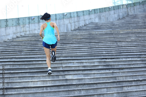 Fototapeta Naklejka Na Ścianę i Meble -  young fitness woman runner running on stairs
