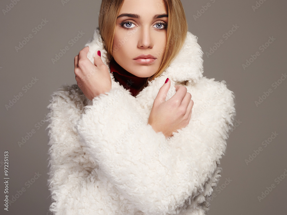 Gorgeous young woman in winter fashion wearing a fur.beautiful blond girl