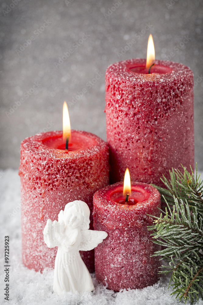 Three red candles on gray background, Christmas decoration. Adve Three red candles on gray background, Christmas decoration. Adve