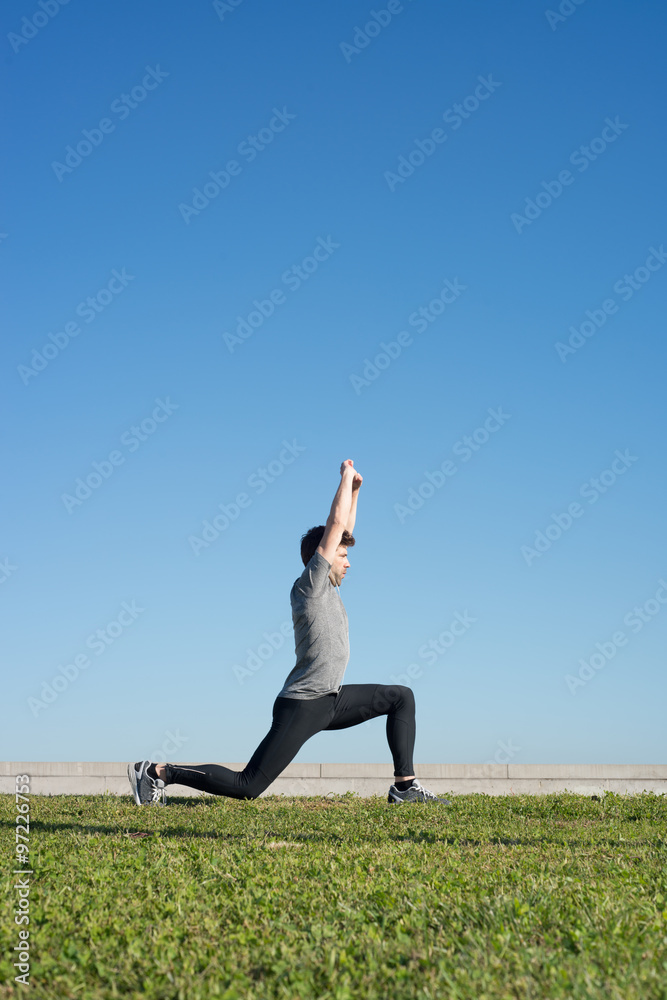 Man doing strechings after running space for text up Man doing strechings after running space for text up