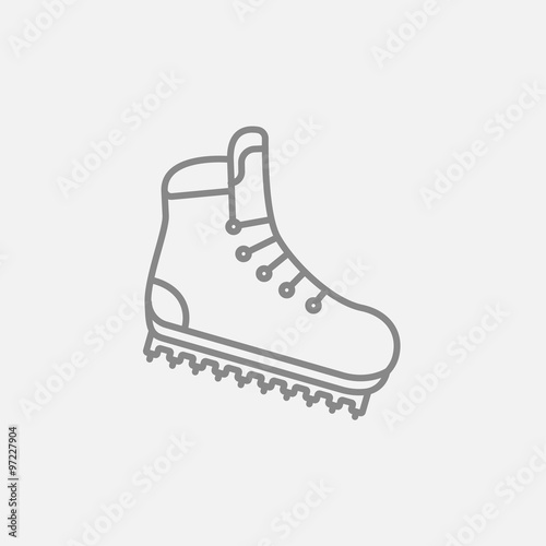 Hiking boot with crampons line icon.