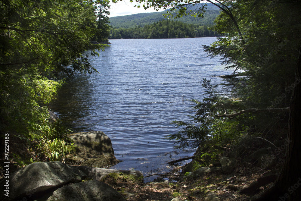 Fototapeta premium Shoreline and fresh water of Mountain View Lake in Sunapee, New Hampshire.