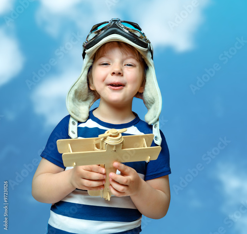 portrait small child playing with an airplane, abstract backgrou