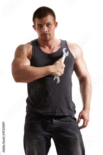 young muscular worker with a wrench