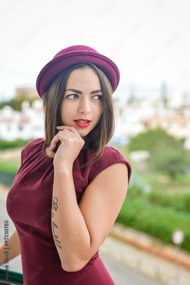 Attractive pensive brunette looking into distance standing on balcony alone