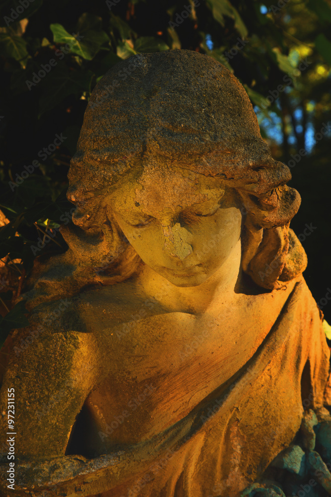 Fototapeta premium golden angel in the sunlight (antique statue)