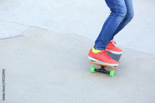 skateboarding legs riding on a skateboard