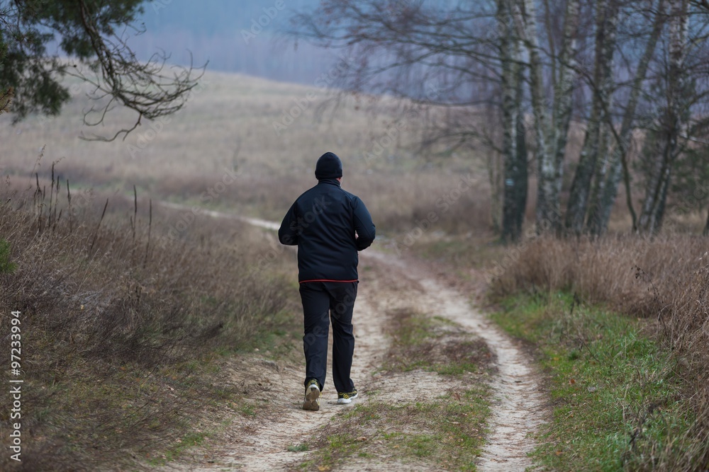 Man running by country rural sandy road Man running by country rural sandy road