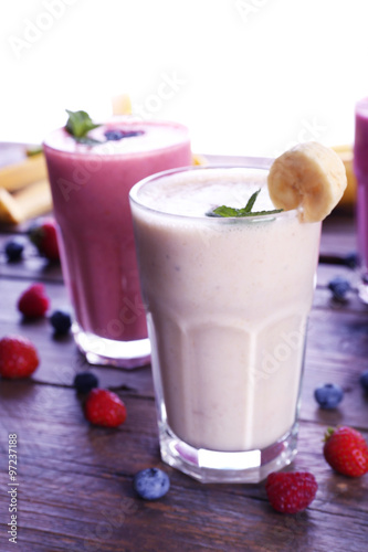 Glasses of fresh cold smoothie with fruit and berries, isolated on white