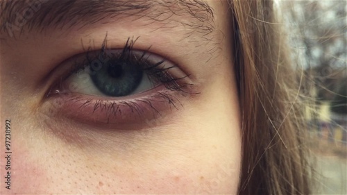 open female blue eye in 1080p a beautiful girl staring into the camera