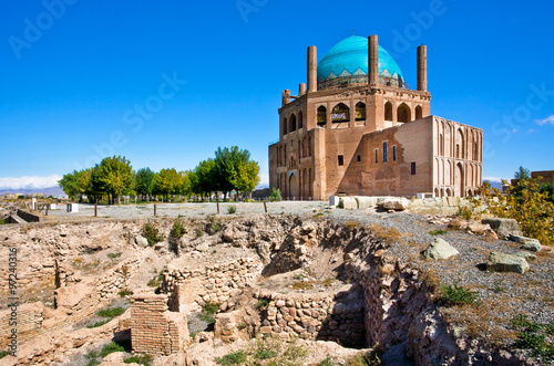 Ruins of stone citadel and historical mausoleum Dome of Soltaniyeh background. The structure, erected in 1312 AD in Iran.