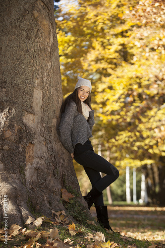 Beautiful happy woman in autumn park,shallow depth of field. Fall season