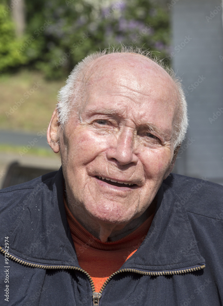 smiling happy senior man sitting in his garden smiling happy senior man sitting in his garden