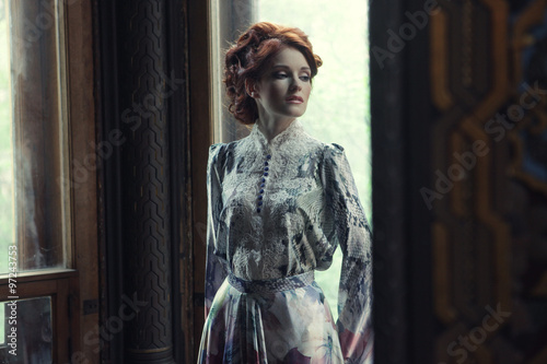 Obraz na plátně beautiful woman in pink dress posing in luxury palace