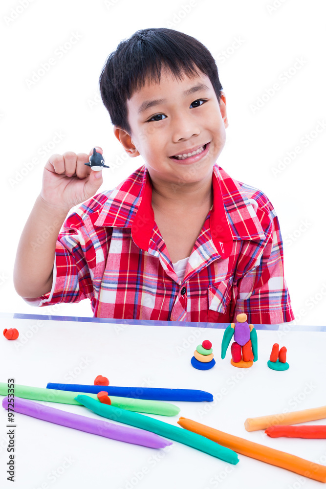 Child show his works from clay, over white. Strengthen the imagination of child
