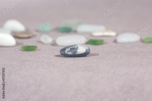 Colorful stones on the ground. This image shows that every individual is important for the whole team metaphorically speaking. Image has a vintage effect applied.