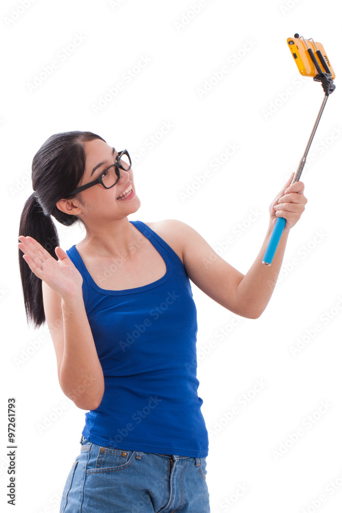 Happy woman taking picture with smartphone selfie stick Happy woman taking picture with smartphone selfie stick