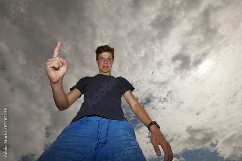 From below a young man angrily threaten