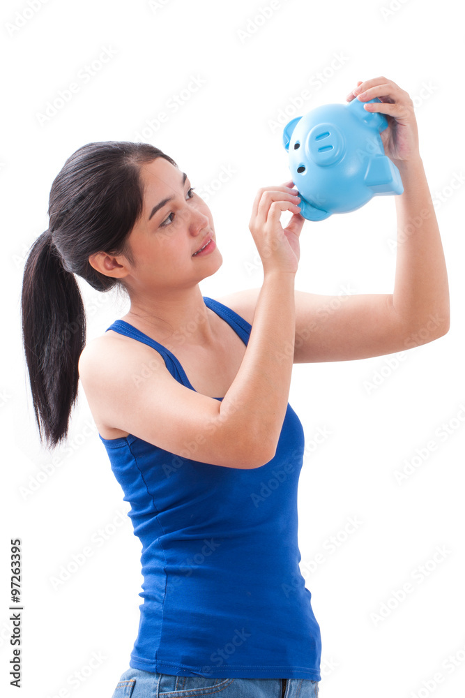 woman trying to get some money out of piggy bank
woman trying to get some money out of piggy bank