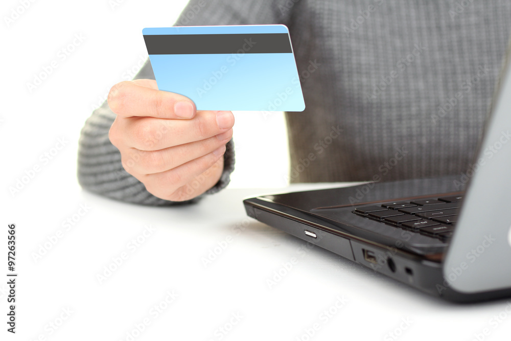 credit card in hand the woman and the opened laptop on white isolated background credit card in hand the woman and the opened laptop on white isolated background