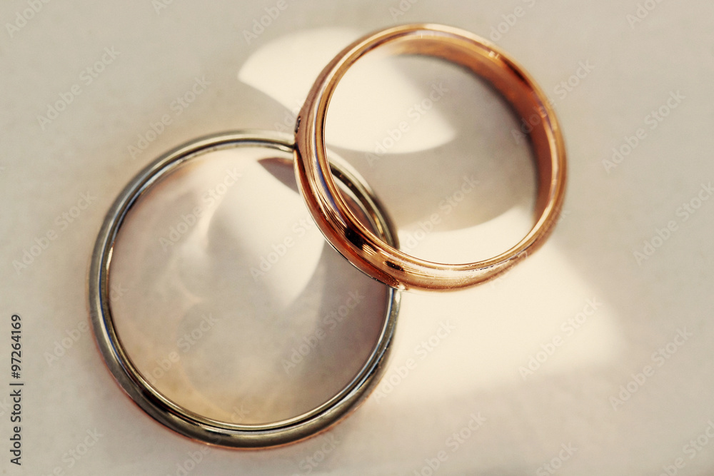 Closeup of two stylish expensive gold and silver wedding rings
