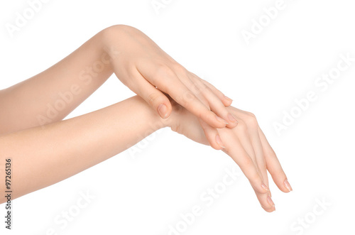 Beauty and Health theme  beautiful elegant female hand isolated on a white background in the studio  using cream advertisement  massage