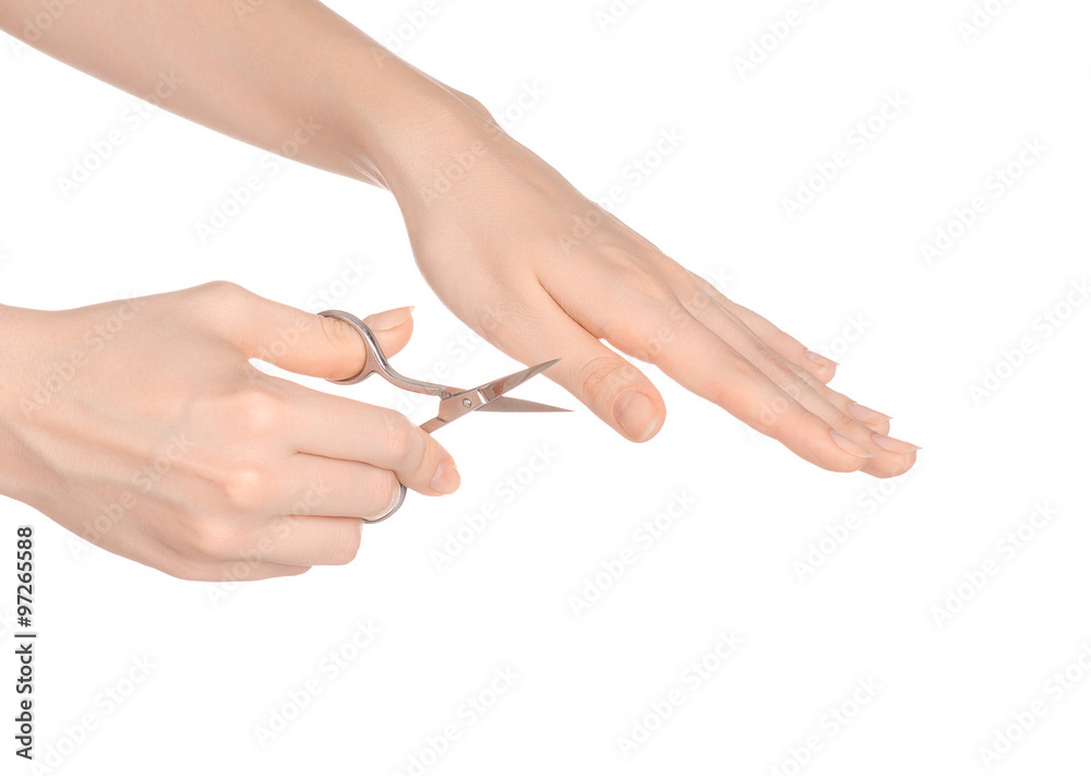 Health and personal care: female hand holding scissors for manicure isolated on white background in studio Health and personal care: female hand holding scissors for manicure isolated on white background in studio