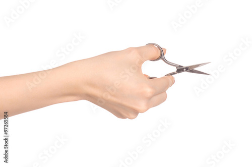Health and personal care  female hand holding scissors for manicure isolated on white background in studio