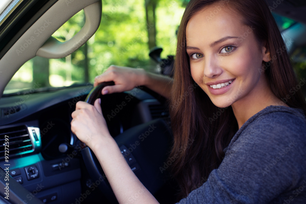 Naklejka premium Beautiful young happy woman in car.