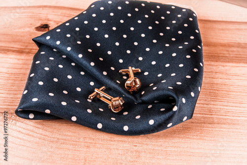 silver cuff links and red bow tie